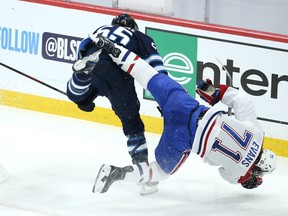 Winnipeg Jets centre Mark Scheifele (left) level Montreal Canadiens centre Jake Evans after his empty-net goal during Game 1 of the North Division final in Winnipeg on Wed., June 2, 2021. KEVIN KING/Winnipeg Sun/Postmedia Network