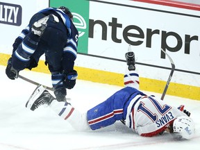 Winnipeg Jets centre Mark Scheifele (left) level Montreal Canadiens centre Jake Evans after his empty-net goal during Game 1 of the North Division final in Winnipeg on Wed., June 2, 2021. KEVIN KING/Winnipeg Sun/Postmedia Network