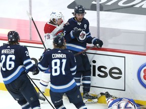 Winnipeg Jets centre Mark Scheifele (top right) reacts as Montreal Canadiens centre Jake Evans lays on the ice following his hit late in Game 1 of the North Division final in Winnipeg on Wed., June 2, 2021. KEVIN KING/Winnipeg Sun/Postmedia Network