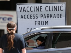 Activity near a COVID-19 vaccination clinic in Winnipeg on Friday.