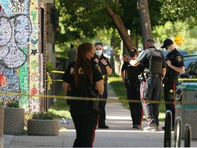 Winnipeg Police Service members at a shooting scene near the intersection of Young Street and Balmoral Avenue in Winnipeg on Monday, June 14, 2021. Police would only say that a victim of a gunshot wound was transported to hospital.
