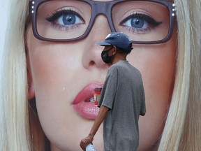 A person wears mask while walking in public in Winnipeg on Friday, June 18, 2021.
