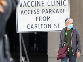 People walk near the COVID-19 vaccination clinic at RBC Convention Centre in Winnipeg on Sunday, June 27, 2021.