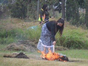 A community member in Sagkeeng First Nation keeps watch over a sacred fire on Wednesday, while just yards away drones searched the grounds of the former Fort Alexander residential school for unmarked graves.
Dave Baxter/Winnipeg Sun