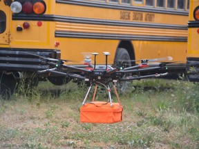 A drone flies near a school bus depot in Sagkeeng First Nation on July 21, 2021 searching for unmarked graves near the sight of the former Fort Alexander residential school. Dave Baxter/Winnipeg Sun/Local Journalism Initiative