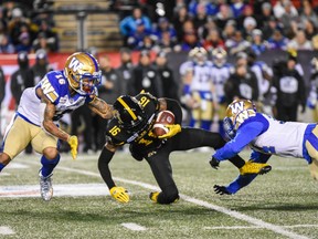 Winnipeg Blue Bombers Mikes Jones (16) and Marcus Sayles tackle Brandon Banks during the Grey Cup CFL championship football game on Sunday, Nov. 24, 2019.