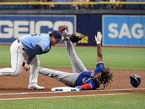 Vladimir Guerrero Jr. of the Toronto Blue Jays is thrown out at first base by Mike Zunino #10 (not pictured) as Ji-Man Choi #26 of the Tampa Bay Rays makes the tag during the first inning at Tropicana Field on Saturday.