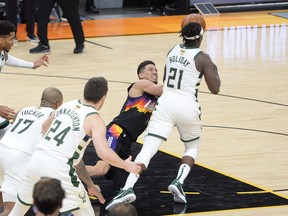 Milwaukee Bucks guard Jrue Holiday steals the ball form Phoenix Suns guard Devin Booker during Game 5.