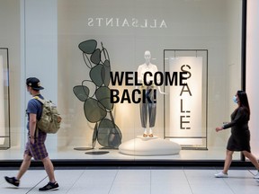 People walk in the Eaton Centre shopping mall, as the provincial Phase 2 of reopening from COVID-19 restrictions begins in Toronto, June 24, 2020.