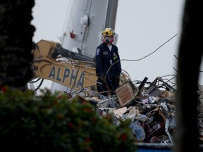 A rescue worker works on top of the collapsed 12-story Champlain Towers South condo building on July 10, 2021 in Surfside, Fla.