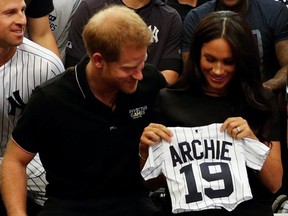 Prince Harry, Duke of Sussex and Meghan, Duchess of Sussex with a gift from the Yankees before their game against the Red Sox at London Stadium in London, England, June 29, 2019.