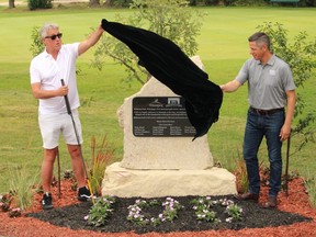 Mayor Brian Bowman and Coun. Ross Eadie unveil a commemorative plaque on Wednesday celebrating the 100th anniversary of the Kildonan Park Golf Course in Winnipeg’s North End. James Snell/Postmedia