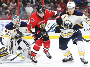 Robin Lehner, left, and Rasmus Ristolainen, right, of the Buffalo Sabres battle against Bobby Ryan of the Ottawa Senators during third period of NHL action at Canadian Tire Centre in Ottawa, Feb. 14, 2017.