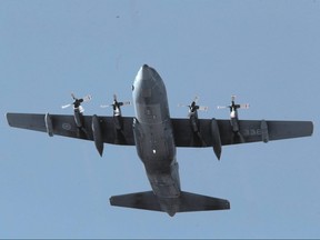 A C-130 Hercules aircraft in the air over Winnipeg.