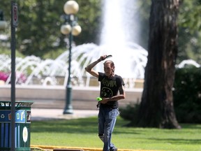 A person walks past a large fountain on Assiniboine Avenue in Winnipeg on Wednesday, July 14, 2021.