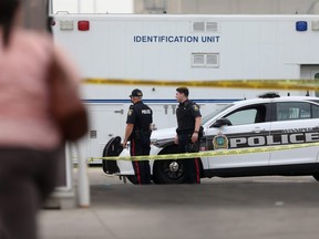 Police at the scene of a homicide near a shop in the 100 block of Salter Street in Winnipeg.  Wednesday, July 28/2021.Winnipeg Sun/Chris Procaylo/stf