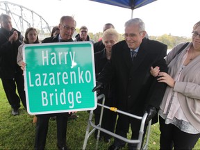 The Redwood Bridge was renamed to honour long time city councillor Harry Lazarenko on Friday, October 3, 2014. This is Mayor Sam Katz showing former councillor Harry Lazarenko the new sign. Friday, October 3, 2014.