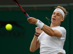 Canada's Denis Shapovalov returns against Spain's Roberto Bautista Agut during their men's singles fourth round match on the seventh day of the 2021 Wimbledon Championships at The All England Tennis Club in Wimbledon, southwest London, on July 5, 2021.