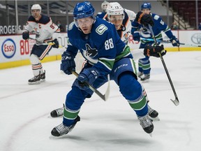 Edmonton Oilers forward Jesse Puljujarvi (13) chases after Vancouver Canucks defenceman Nate Schmidt (88) in the first period at Rogers Arena in Vancouver on May 3, 2021.