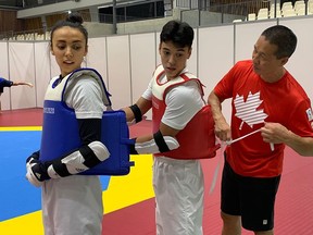 Taekwondo athlete Skylar Park (left) is supported by her younger brother, Tae-Ku, and father and coach, Jae, at the Tokyo Olympics.