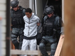 Heavily armed police took numerous people into custody from a residence in the vicinity of Dufferin Avenue and McGregor Street in Winnipeg on Thursday, July 8, 2021.
