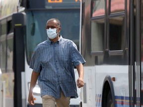 A person wears a mask while walking outside in Winnipeg on Friday, July 16, 2021.