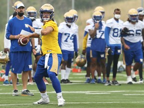 Quarterback Zach Collaros throws with offensive co-ordinator Buck Pierce looking on during Winnipeg Blue Bombers training camp on the University of Manitoba campus in Winnipeg on Monday, July 19, 2021.