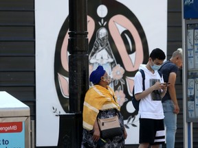 People wear masks while in public in Winnipeg on Friday, July 23, 2021