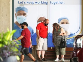 People stop and talk outside the COVID-19 vaccination site at RBC Convention Centre in Winnipeg on Monday, July 26, 2021.