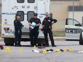 Police at the scene of a homicide near a convenience store in the 100 block of Salter Street in Winnipeg on Wednesday, July 28, 2021.