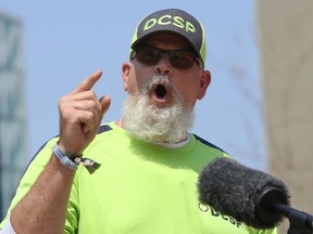 Mitch Bourbonneire, Downtown Community Safety Partnership community outreach liaison, gives an emotional speech during a press conference for a one-year update on the program, in Millennium Library Park in Winnipeg, on Tuesday, July 27,  2021.