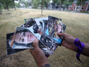 Arlene Last-Kolb displays some of the photos of overdose victims that will be tied to trees with purple ribbon by Overdose Awareness Manitoba on Friday, July 30, 2021.