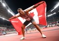 Andre De Grasse of Team Canada celebrates after winning the bronze medal in the Men's 100m Final on day nine of the Tokyo 2020 Olympic Games at Olympic Stadium.