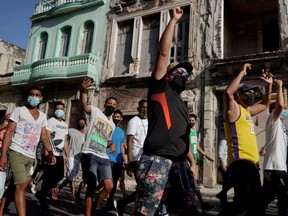 People shout slogans against the government during a protest against and in support of the government, amidst the COVID-19 outbreak, in Havana, Cuba, July 11, 2021.