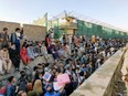 Crowds of people wait outside the airport in Kabul, Afghanistan August 25, 2021 in this picture obtained from social media.