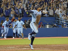 Toronto Blue Jays centre fielder George Springer (4) reacts after hitting a home run against the Boston Red Sox at Rogers Centre.