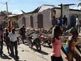 People watch destroyed houses after an earthquake struck on August 14, 2021 in Jeremie, South West Haiti. - A powerful 7.2-magnitude earthquake struck Haiti early Saturday, killing people and toppling buildings in the disaster-plagued Caribbean nation still recovering from a devastating 2010 quake. The epicenter of the shaking, which rattled homes and sent terrified locals scrambling for safety, was about 100 miles (160 kilometers) by road west of the center of the densely populated capital Port-au-Prince.