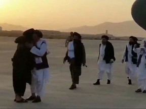 This file handout video grab taken from a footage released by Taliban-affiliated Al Hijrat TV on August 17, 2021 shows Mullah Abdul Ghani Baradar's arrival in Afghanistan, in Kandahar.