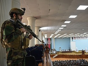 A Taliban Fateh fighter, a "special forces" unit, stands guard as Talibans acting Higher Education Minister Abdul Baqi Haqqani (not pictured) addresses a gathering during a consultative meeting on Taliban's general higher education policies at the Loya Jirga Hall in Kabul on August 29, 2021.