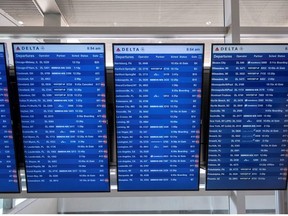 Flight information display screens are seen at the Detroit Metropolitan Wayne County Airport in Detroit, Michigan, U.S. June 12, 2021.