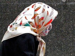 A woman with a colorful hijab walks in downtown Edmonton on March 2, 2021.