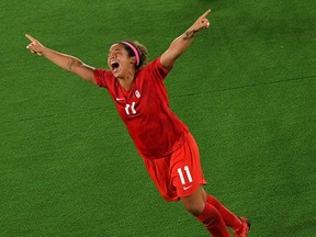 Canada's midfielder Desiree Scott celebrates winning the gold medal after the penalty shoot-out of the Tokyo 2020 Olympic Games women's final football match between Sweden and Canada at the International Stadium Yokohama in Yokohama on Aug. 6, 2021.