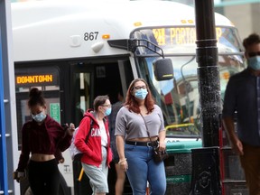Two people wear masks in downtown Winnipeg.  Wednesday, August 11/2021.Winnipeg Sun/Chris Procaylo/stf