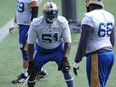 Jermarcus Hardrick (left) talks shop with fellow offensive tackle Stanley Bryant during Winnipeg Blue Bombers practice on Tues., Aug. 10, 2021.