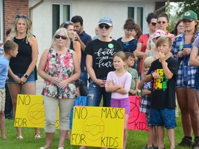 Hundreds gathered in front of the Hanover School Division board office in Steinbach on Monday, Aug. 30, 2021, to protest mandates that will require students and staff in Manitoba to wear masks while in school.