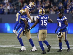 Winnipeg Blue Bombers K Marc Liegghio (top left) is carried by OL Jermarcus Hardrick after hitting the winning field goal against the Calgary Stampeders during CFL action at IG Field in Winnipeg on Sunday, Aug. 29, 2021.