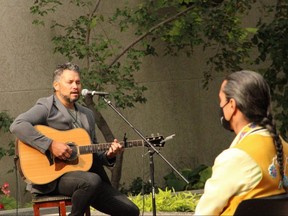 Singer-songwriter Don Amero performs at the fourth annual signing of the Winnipeg Indigenous Accord at city hall campus on Thursday. Grand Chief Arlen Dumas foreground. 
James Snell/Winnipeg Sun