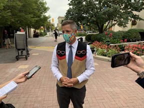 Winnipeg Mayor Brian Bowman speaks with media outside city hall on Thursday.