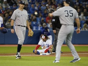 Toronto Blue Jays' Bo Bichette sits on third base after being called out trying to steal against the New York Yankees on Tuesday night.