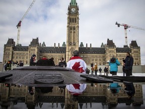 Freedom Forum Canada holds a protest about their rights and freedoms and to end the lockdown, on Parliament Hill in Ottawa, Feb. 14, 2021.